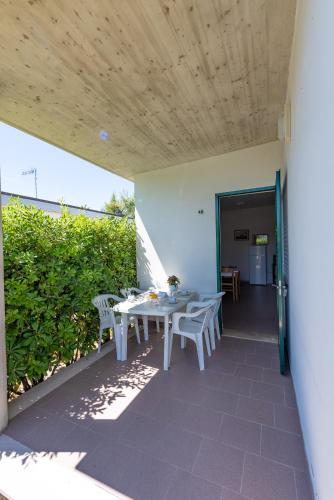 a patio with a table and chairs on it at Club del Sole Stork Family Collection in Giulianova