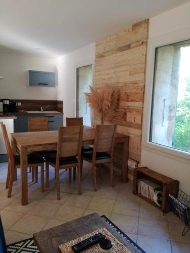 une salle à manger avec une table et des chaises en bois dans l'établissement L'Echevine en vercors, à Échevis