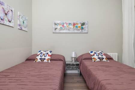 ロスピタレート・デ・リョブレガートにあるCamp Nou , Fira Barcelona Apartmentのベッド2台が隣同士に設置された部屋です。