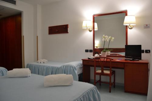 Postel nebo postele na pokoji v ubytování Tafuri Hotel