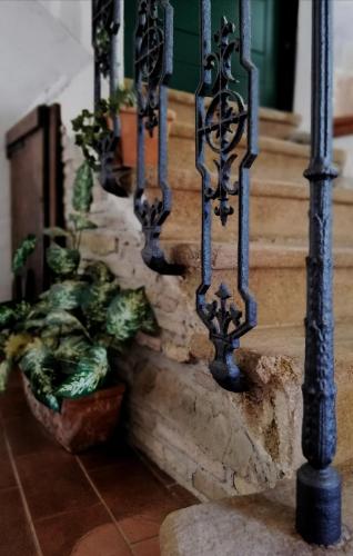 a set of wrought iron stairs with potted plants at La Spelonca degli Asini in Prata
