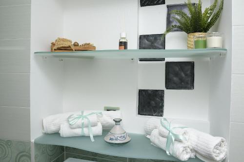 a bathroom with a blue shelf with towels and plants at Casa Nanà Amalfi Coast in Vietri