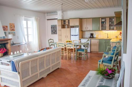 a kitchen and living room with a table and chairs at Pine Trees and Sea View Houses in Hydra - Daphne, Chloe, Myrto, Eleni in Hydra