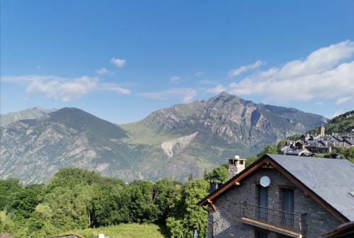 a house with a view of mountains in the background at Hostal Rural Sant Climent - Habitacions i Apartaments in Taull