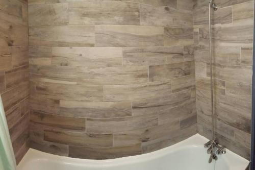 a bathroom with a shower with wooden walls at La Rosière Montvalezan,pieds des pistes,résidence le Vanoise in La Rosière