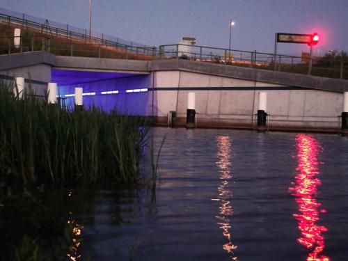 a bridge over a river with a red traffic light at Ferienwohnung Seenland in Großräschen