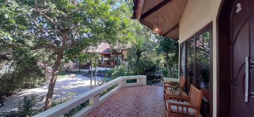 a walkway leading to a house with a porch at Bara Beach Bungalows in Bira