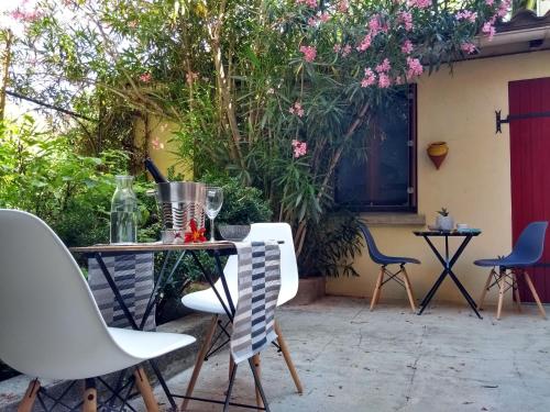 a table and chairs on a patio with flowers at Number15 Guesthouse Carcassonne in Carcassonne