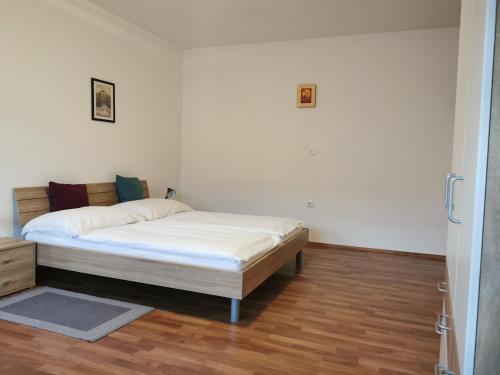 a bedroom with a bed in the corner of a room at Hotel Goldene Krone in Mistelbach