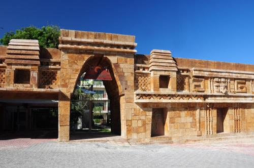 a brick building with an arch in the middle at Hotel Posada Sian Kaan Playa del Carmen in Playa del Carmen