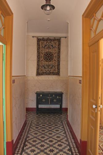 a hallway with a fireplace and a rug on the wall at A CASA DA VILA in Almodôvar
