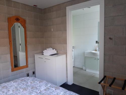 a bedroom with a bed and a mirror and a sink at City Apartment in Christchurch