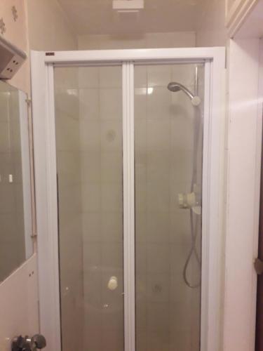 a shower with a glass door in a bathroom at Witton house in Blackpool