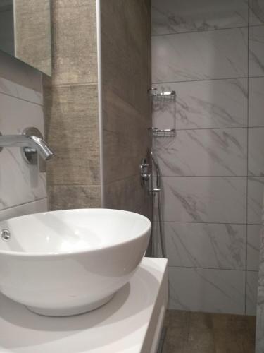 a bathroom with a white sink and a shower at Makedonia in Potos