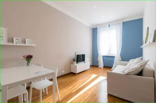 ein Wohnzimmer mit einem weißen Tisch und einem Sofa in der Unterkunft Carlo's BCF3 - Sanremo Centro: my Suites in Sanremo
