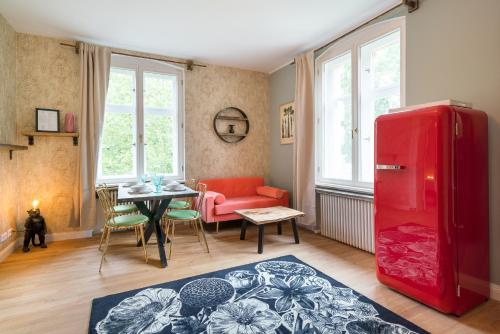 a living room with a red refrigerator and a table at Design Apartments - "Villa Arnim" in Potsdam