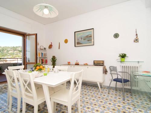 a white dining room with a white table and chairs at Apartment Top Floor by Interhome in Sorrento