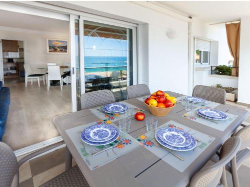 Apartment Fenals Beach by Interhome في يوريت دي مار: غرفة طعام مع طاولة مع وعاء من الفواكه