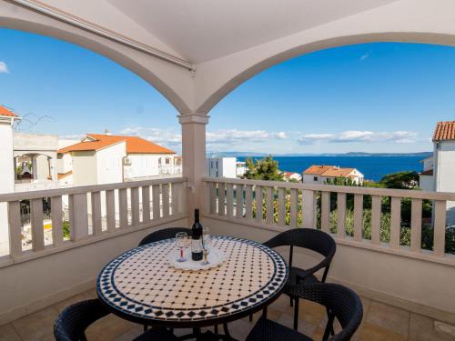 una mesa con una botella de vino en el balcón en Apartment Villa MatAna-1 by Interhome en Trogir