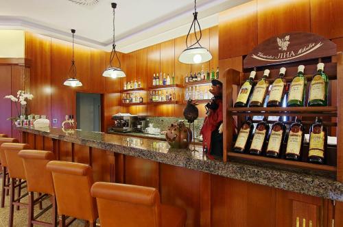 a bar with a bunch of bottles of wine at Kúpele Brusno - Kúpeľný hotel Poľana in Brusno