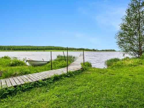 a dock with a boat next to a body of water at Holiday Home Kuoppamäki by Interhome in Lapinlahti