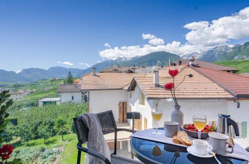 a table with a bowl of food on a balcony at Orizzonti d'Anaunia in Tassullo