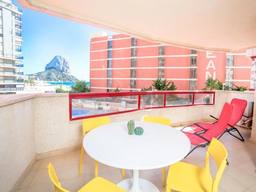 a table and chairs on a balcony with a view of a mountain at Apartment Amatista-7 by Interhome in Calpe