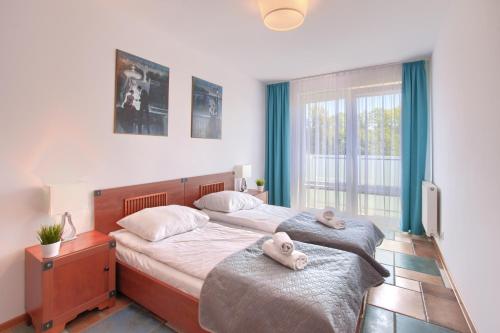 a bedroom with two beds with towels on them at Apartamenty PROMENADA - Aquarius in Kołobrzeg