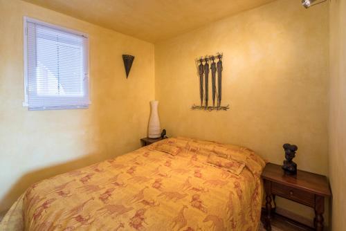 a bedroom with a bed and a window at locaportleucate in Leucate