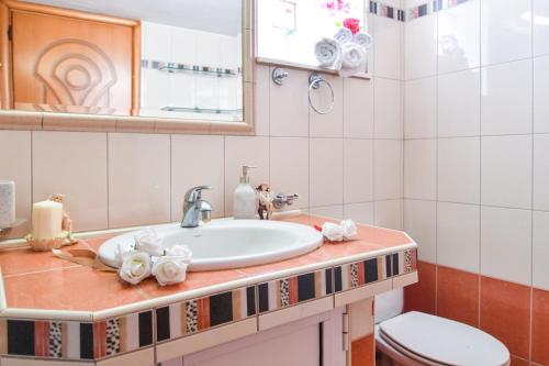 a bathroom with a sink and a toilet at House Ilias in Sarti