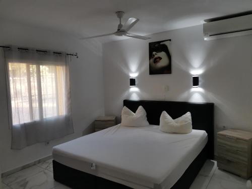 a bedroom with a large white bed with two pillows at Villa Romeo in Calpe