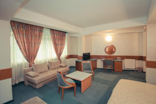 a hotel room with a couch and a table at Hotel Cingo in Ohrid
