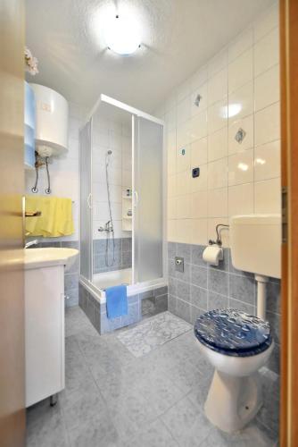 a bathroom with a toilet and a shower and a sink at Villa Senjkovic - Apartments with Balcony and Sea View in Bol
