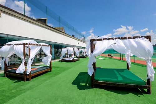 a group of beds sitting on a field of grass at Spa Hotel Select - Halfboard in Velingrad