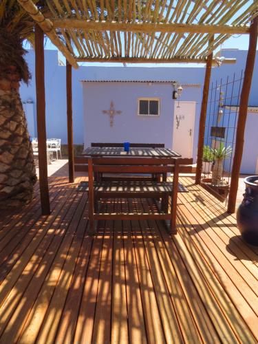 a wooden deck with a bench on top of it at Haus Sandrose in Lüderitz