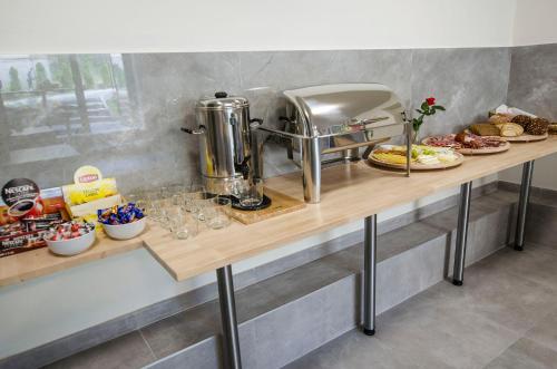 a table with food on it in a kitchen at Bema Rooms in Łódź