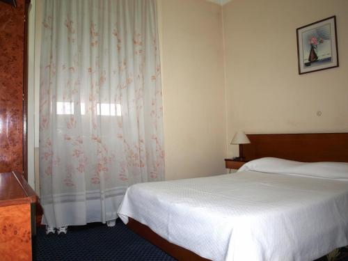 Postel nebo postele na pokoji v ubytování D. Carlos Residencial