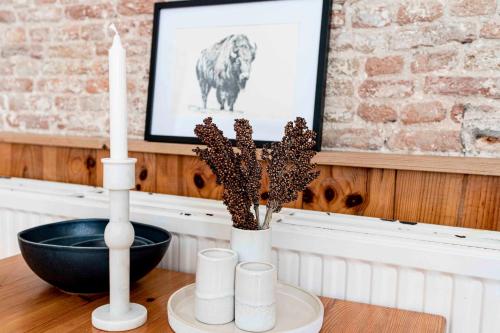 two white candles and a black bowl on a table at Hofstede Villetta in Zonnemaire