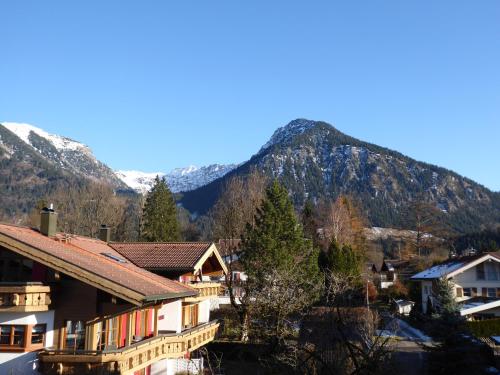 a town with a mountain in the background at Apartmenthotel Oberstdorf in Oberstdorf