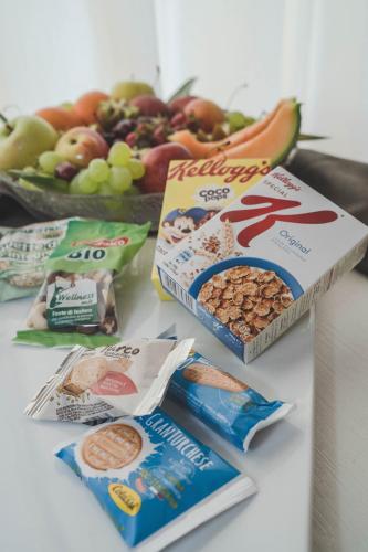 three boxes of cereals and fruit on a table at Hotel Niagara in Catanzaro Lido