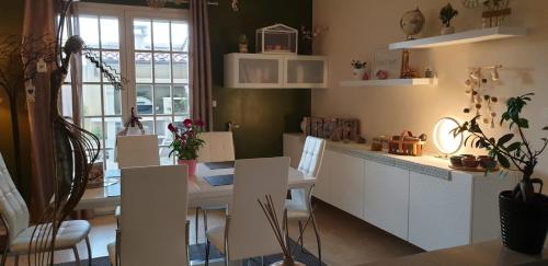 a kitchen and dining room with a table and chairs at Villa Solary in Le Pontet