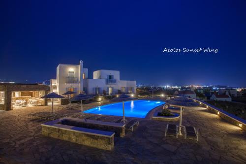 a swimming pool at night with a building at Aeolos Resort in Mýkonos City