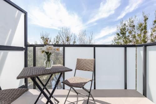 a balcony with a table and two chairs at Deluxe Apartments Sucha Gdańsk by Renters in Gdańsk