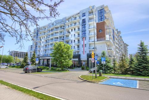 a large building with a lot of windows on the side of the street at Apartamenty Spa Promenada in Kołobrzeg