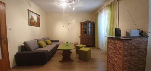 a living room with a couch and a table at Apartments New Charming in Senj