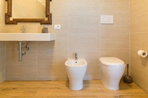 a bathroom with a sink and a toilet at Guest House Bella Onda in Tessera