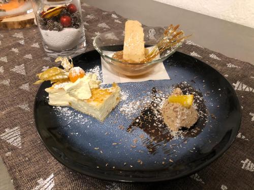 a blue plate with desserts on a table at Gasthof zum Mohrn in Oberwölz Stadt