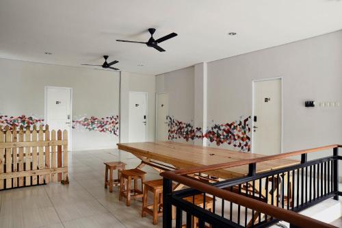 a dining room with a wooden table and chairs at Tuju WK Homes Syariah in Jakarta