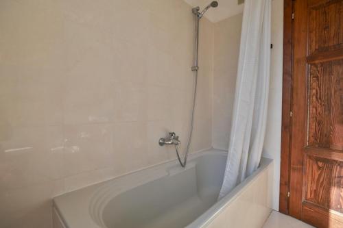 a bathroom with a bath tub with a shower at Contempora Apartments - Ca' Brenta Fresco in San Fedele Intelvi