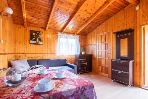 a living room with a table and a couch at Pensjonat Bursztyn in Dąbki